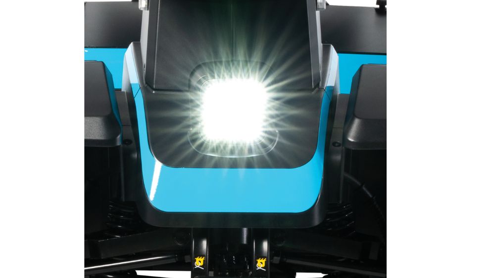 Close-up of a bright white LED headlight on a blue PX4 4-Wheel Scooter from Pride Mobility, featuring angular black accents.