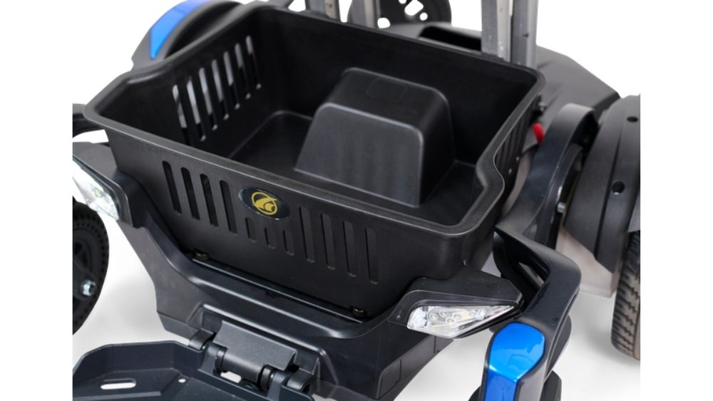Close-up of a black storage basket attached to the Buzzaround CarryOn Power Wheelchair, highlighting its shape and side ventilation slits.
