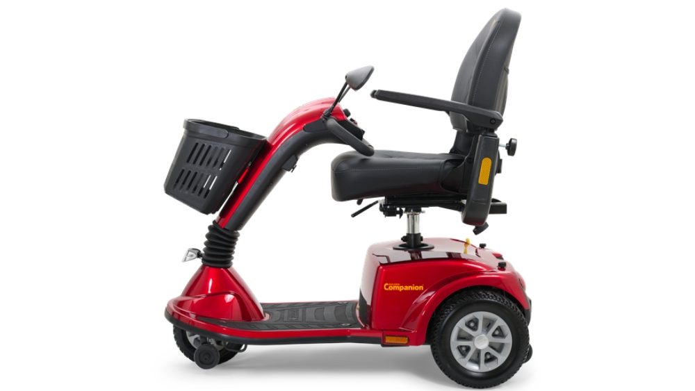 Companion Mid-Size 3-Wheel Scooter in red, featuring a front basket, black seat with armrests, and three wheels, displayed from the side against a white background.
