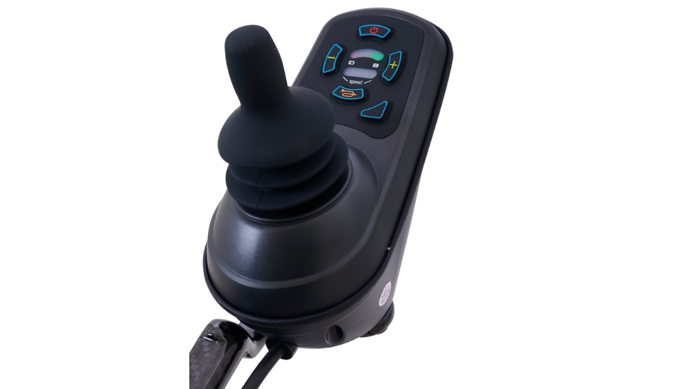 Close-up of a black joystick controller with buttons and indicator lights, designed for the Cricket Folding Power Wheelchair, isolated on a white background.