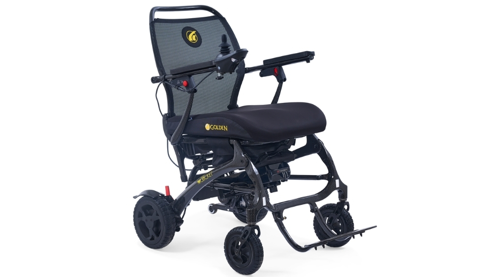 The Cricket Folding Power Wheelchair, shown in black with a mesh backrest, padded seat, armrests, footrest, and four wheels, is photographed against a white background.
