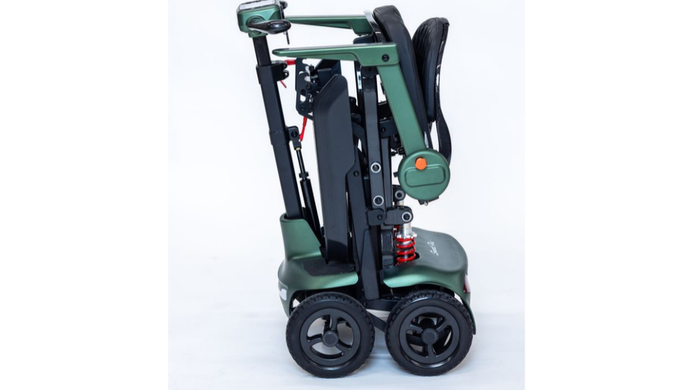 Dark green Monarch Mobility Smarti Plus foldable mobility scooter in its upright, collapsed position.