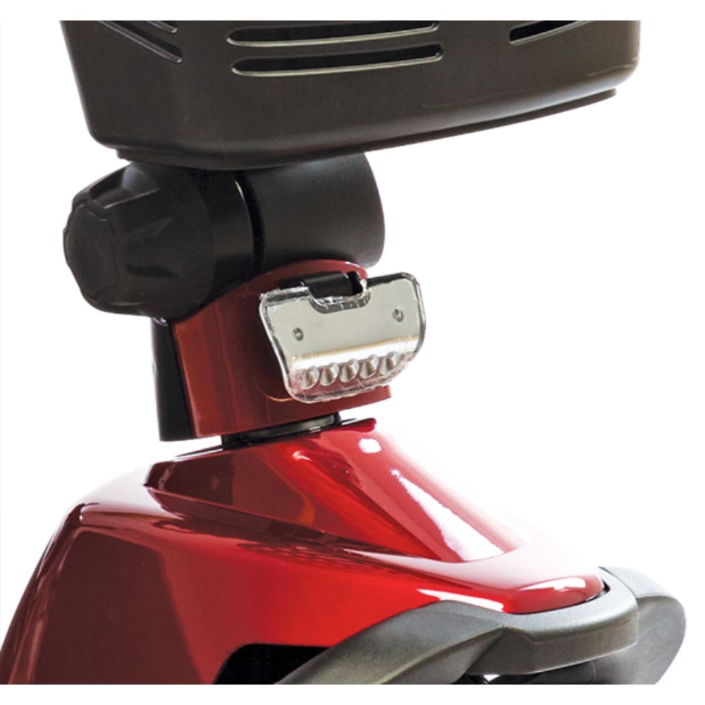 Close-up of the front section of a red Victory 10 3-Wheel Scooter, featuring a mounted headlight and a portion of the black front storage basket positioned above.