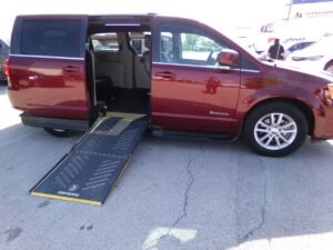 Red Dodge Grand Caravan with Driverge Side Entry Automatic Fold Out conversion