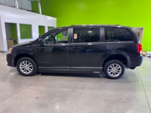 Black Dodge Grand Caravan with Adaptive Vans Side Entry Automatic Fold Out conversion
