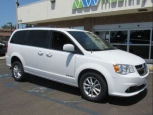 White Dodge Grand Caravan with Driverge Rear Entry Manual Fold Out conversion