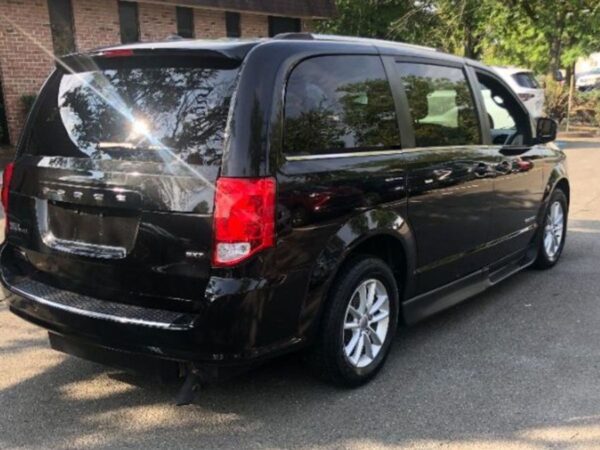 Black Dodge Grand Caravan with Driverge Side Entry Automatic Fold Out conversion