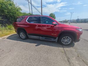 Red Chevrolet Traverse with BraunAbility Side Entry Automatic In Floor conversion