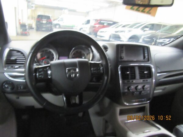 Black Dodge Grand Caravan with Driverge Side Entry Automatic Fold Out conversion