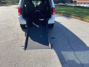 White Dodge Grand Caravan with Driverge Rear Entry Manual Fold Out conversion