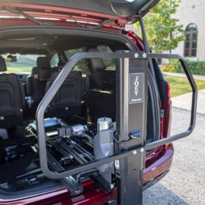 A Bruno Joey Platform Style Interior Lift (VSL-4400) is installed in the rear of a red SUV with its hatch open in a parking lot.