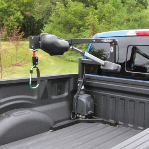 The Bruno PUL-1100HD Out-Rider® is a pickup bed wheelchair lift designed for loading and unloading heavy wheelchairs from your truck. Trees and grass can be seen in the background.