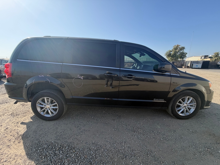 Black Dodge Grand Caravan with Driverge Rear Entry Manual Fold Out conversion