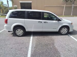 White Dodge Grand Caravan with BraunAbility Rear Entry Automatic Fold Out conversion