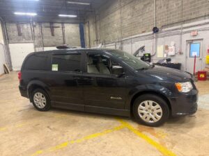 Black Dodge Grand Caravan with BraunAbility Side Entry Automatic Fold Out conversion