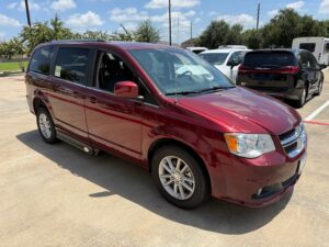 Red Dodge Grand Caravan with Adaptive Vans Side Entry Automatic Fold Out conversion