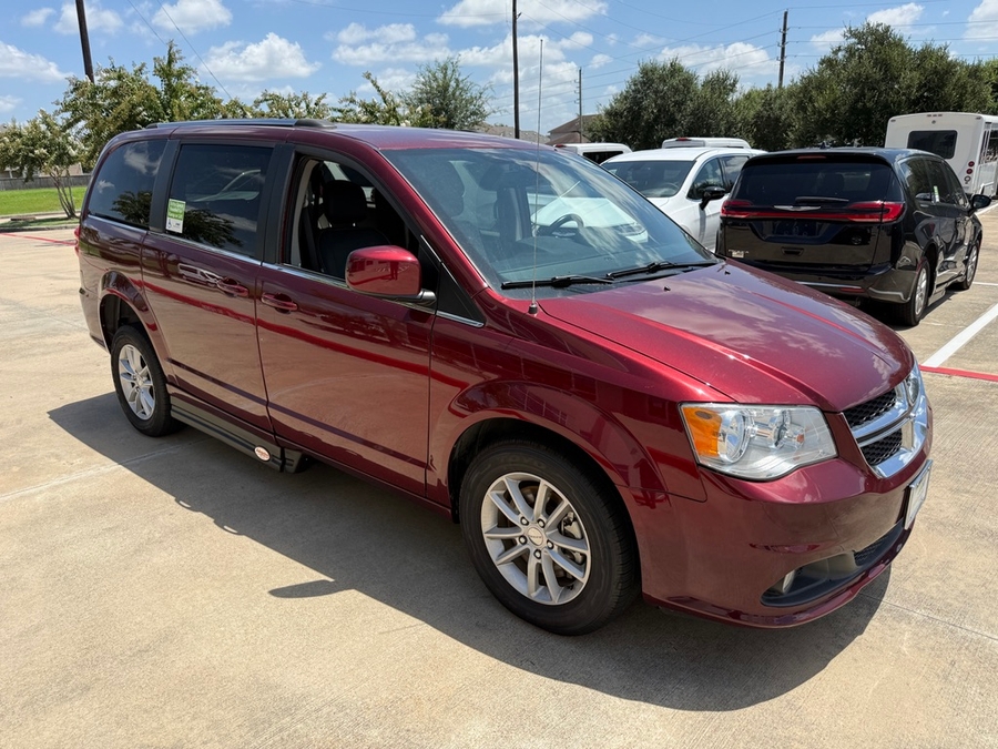 Red Dodge Grand Caravan with Adaptive Vans Side Entry Automatic Fold Out conversion