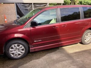 Red Dodge Grand Caravan with BraunAbility Side Entry Automatic Fold Out conversion