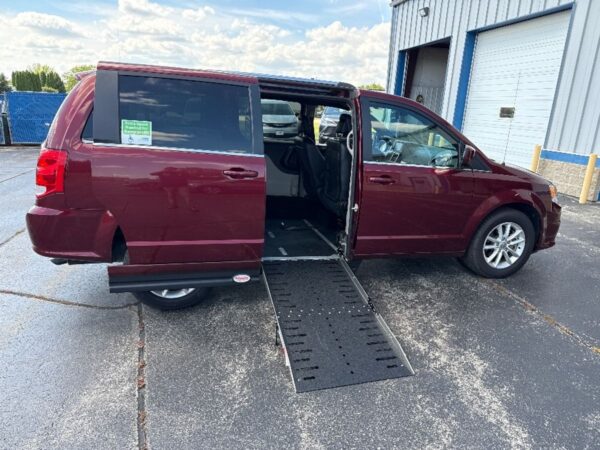 Red Dodge Grand Caravan with Adaptive Vans Side Entry Automatic Fold Out conversion
