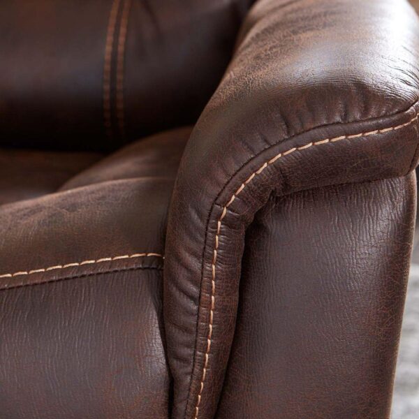 Close-up of the armrest on the Dione Lift Chair, featuring brown leather upholstery with visible stitching and a textured finish.
