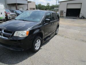 Black Dodge Grand Caravan with BraunAbility Side Entry Automatic Fold Out conversion
