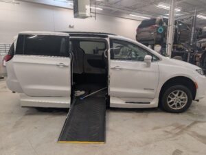 White Chrysler Pacifica with Driverge Side Entry Automatic Fold Out conversion