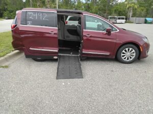 Red Chrysler Pacifica with Adaptive Vans Side Entry Automatic Fold Out conversion