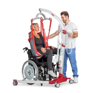 A caregiver is carefully assisting the wheelchair-bound woman using the Molift Mover 180 to ensure her safety and comfort.