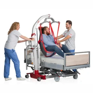 Two healthcare workers carefully use the reliable Molift Mover 300 patient lift to transfer a seated man onto a hospital bed.