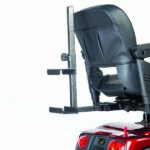 Golden Tech Quad Cane Holder mounted on a red mobility scooter featuring a black seat and attached metal bracket.