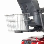 The rear view displays a Golden Tech Rear Basket attached to the back of a mobility scooter, revealing part of the black seat and red scooter body.