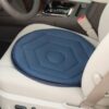 A Swivel Seat Cushion in blue is positioned on a car drivers seat, acting as a functional car safety accessory, with the gear shift and seatbelt visible.