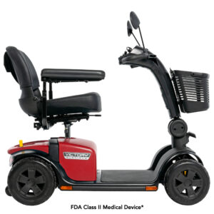 Red four-wheel mobility scooter with black seat, basket at front, and handlebars. Labeled FDA Class II Medical Device. Side profile view.