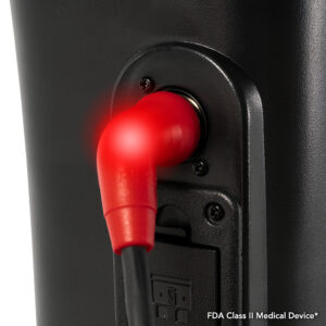 A red plug with a glowing end is connected to a black device. The text reads FDA Class II Medical Device.