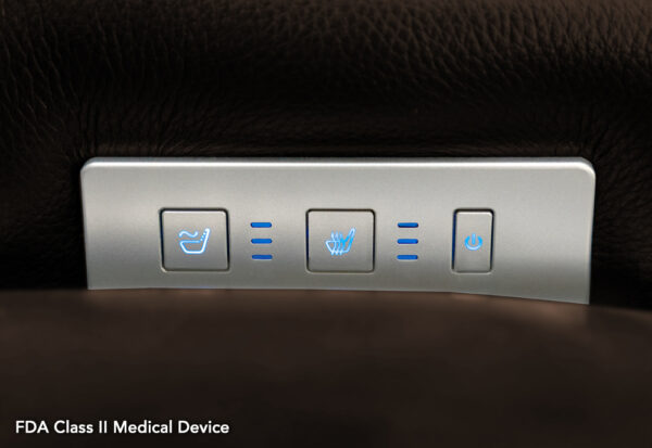 Close-up of the VivaLift! Premier Lift Chairs seat control panel, featuring three illuminated buttons for reclining, seat heating, and power, along with a label stating FDA Class II Medical Device.
